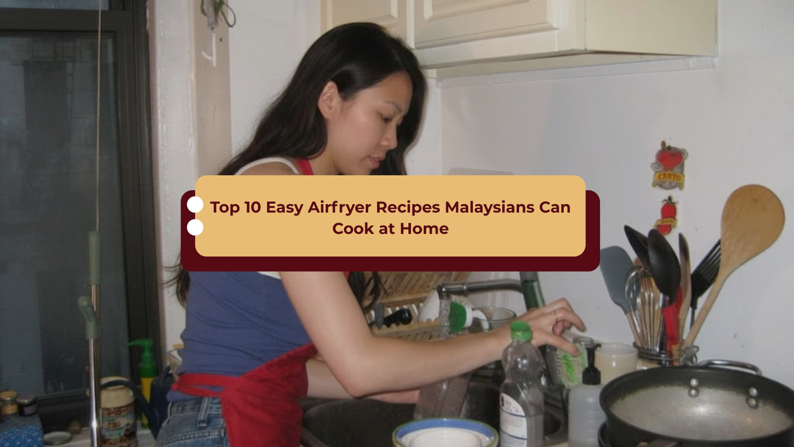 malaysian woman wearing a red apron preparing food at a kitchen sink