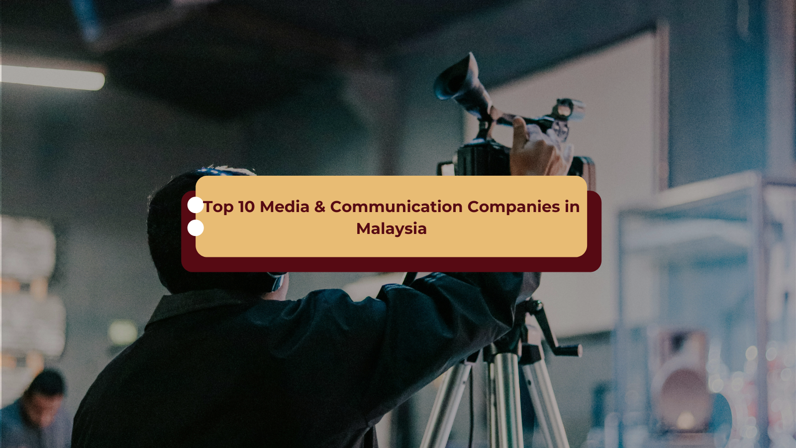 videographer adjusting a professional camera in a studio